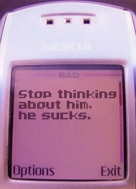 (Image ID: A picture of a Nokia cellphone. The text on the screen reads, "Stop thinking about him. He sucks.")